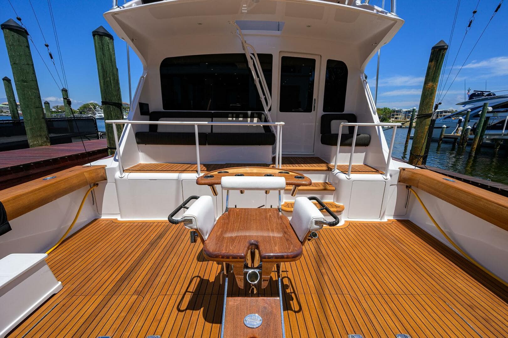 2004 Viking 65 Enclosed Bridge w/Tower, spacious teak deck, fishing chair, docked at marina.