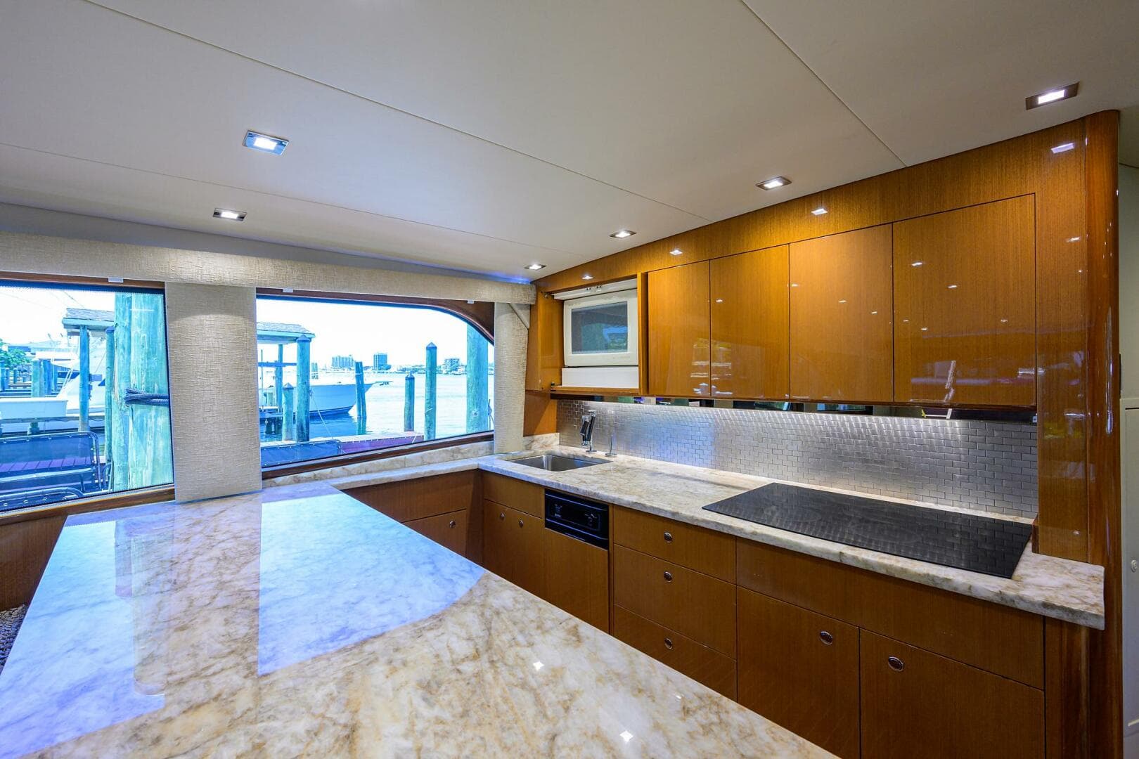 Luxurious kitchen interior of 2004 Viking 65 Enclosed Bridge yacht with marble countertops.