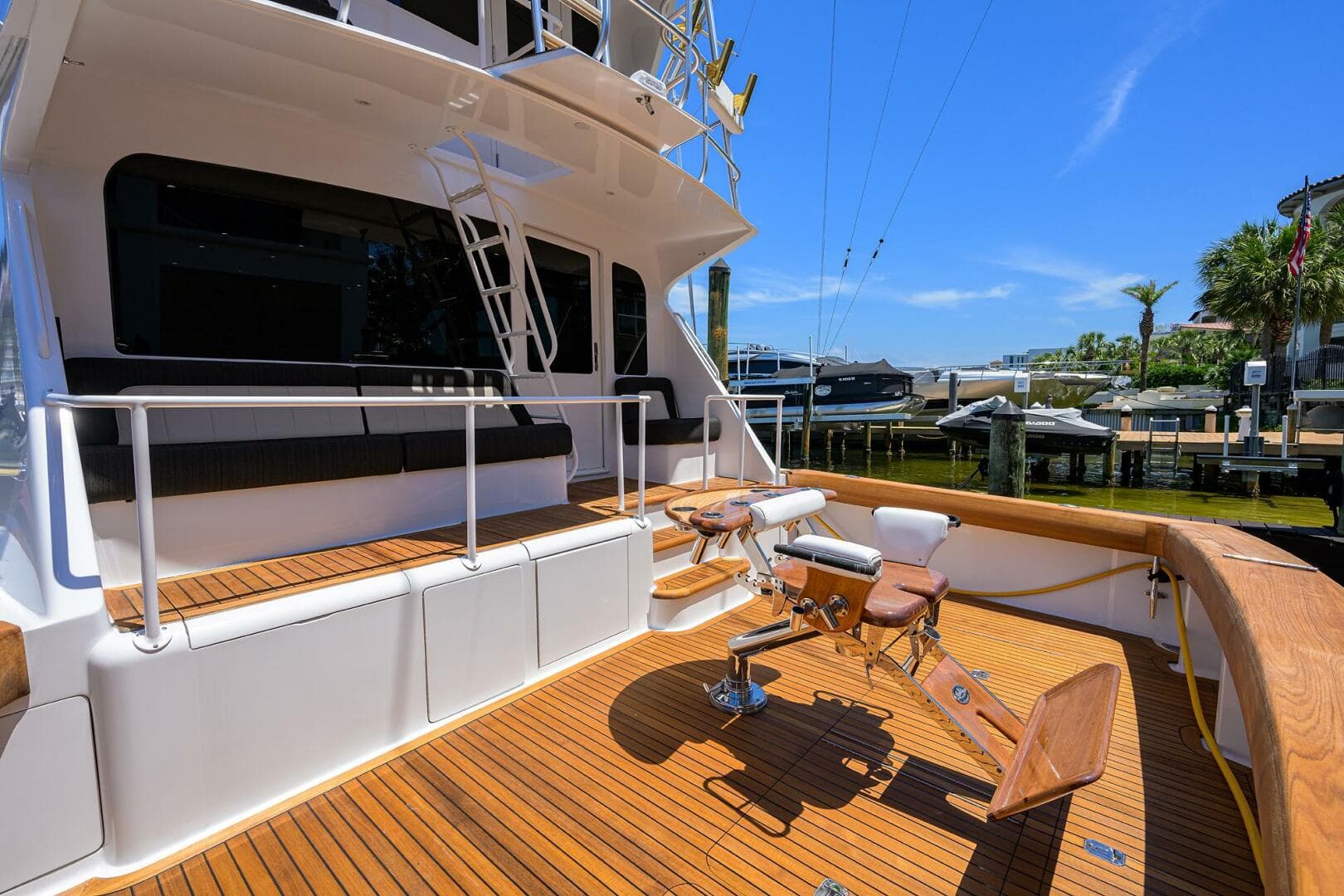 2004 Viking 65 Enclosed Bridge w/Tower yacht deck with fishing chair and seating.