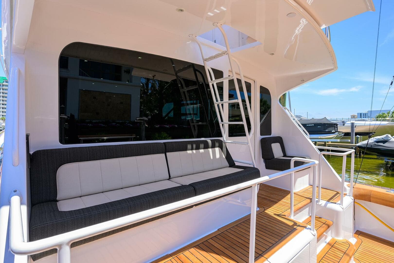 2004 Viking 65 Enclosed Bridge yacht with tower, featuring spacious outdoor seating and ladder access.