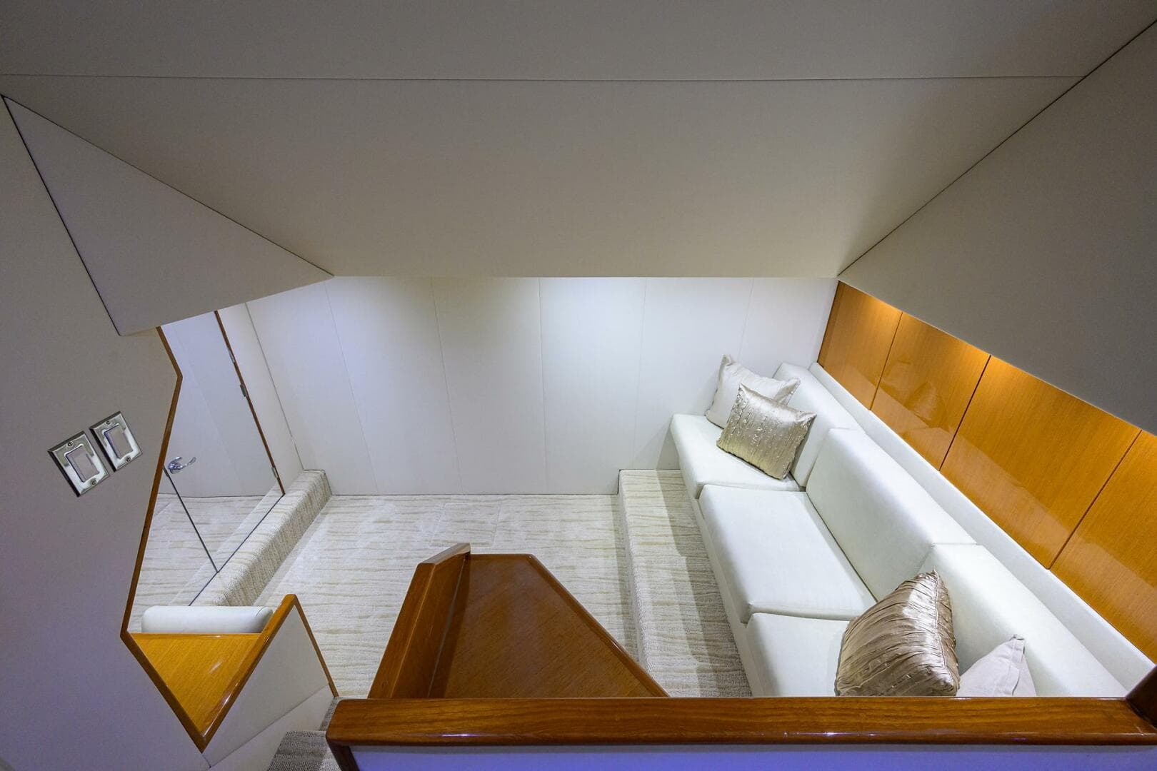 Luxurious interior of 2004 Viking 65 Enclosed Bridge yacht with white sofa and wooden accents.