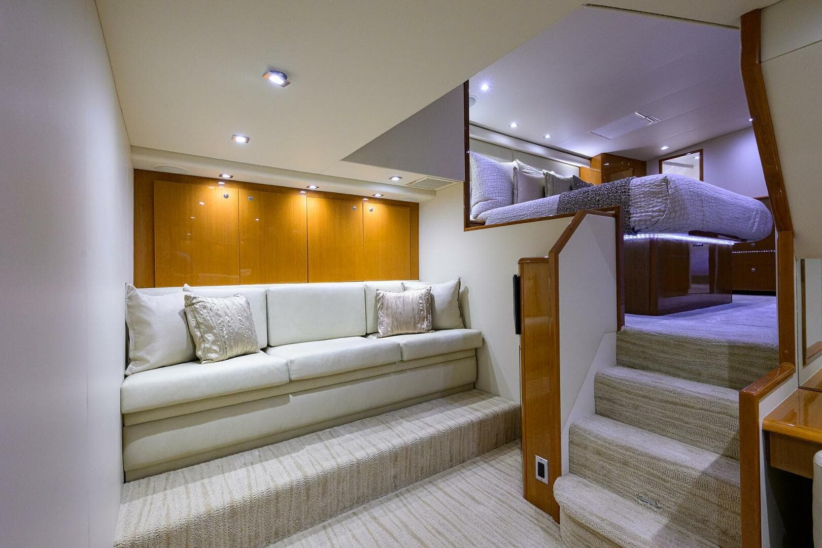 Luxurious interior of 2004 Viking 65 Enclosed Bridge yacht with elegant seating and stairs.