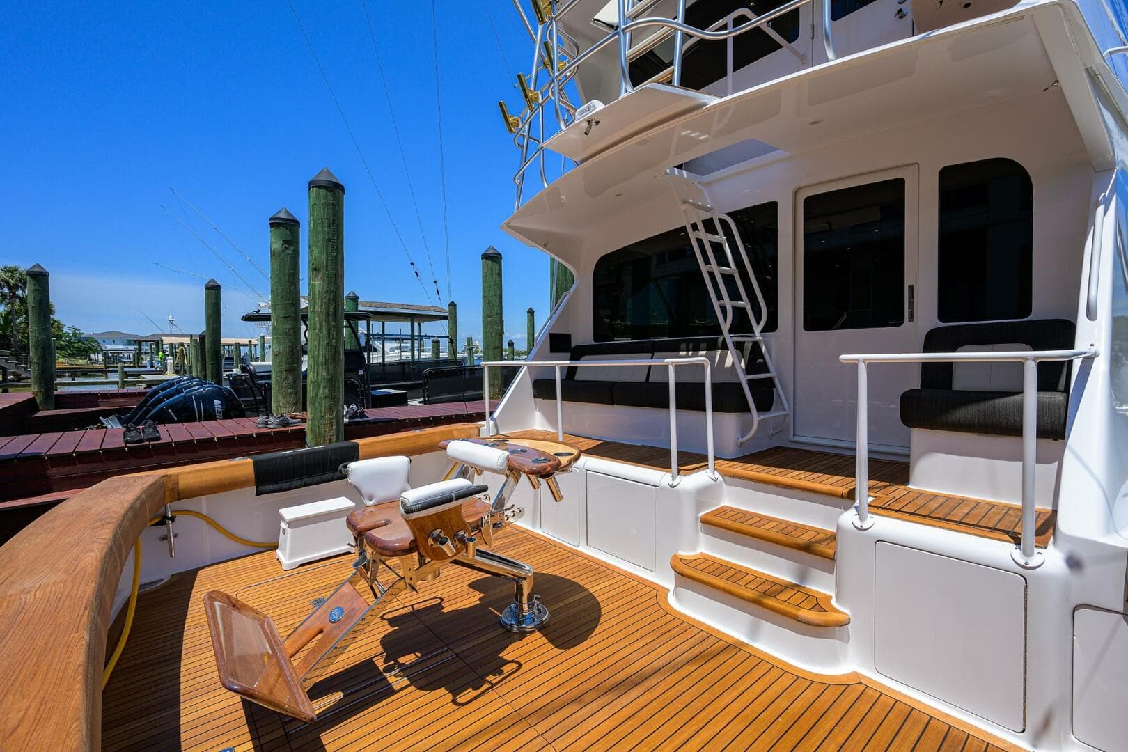 2004 Viking 65 Enclosed Bridge w/Tower yacht deck with seating and fishing chair.