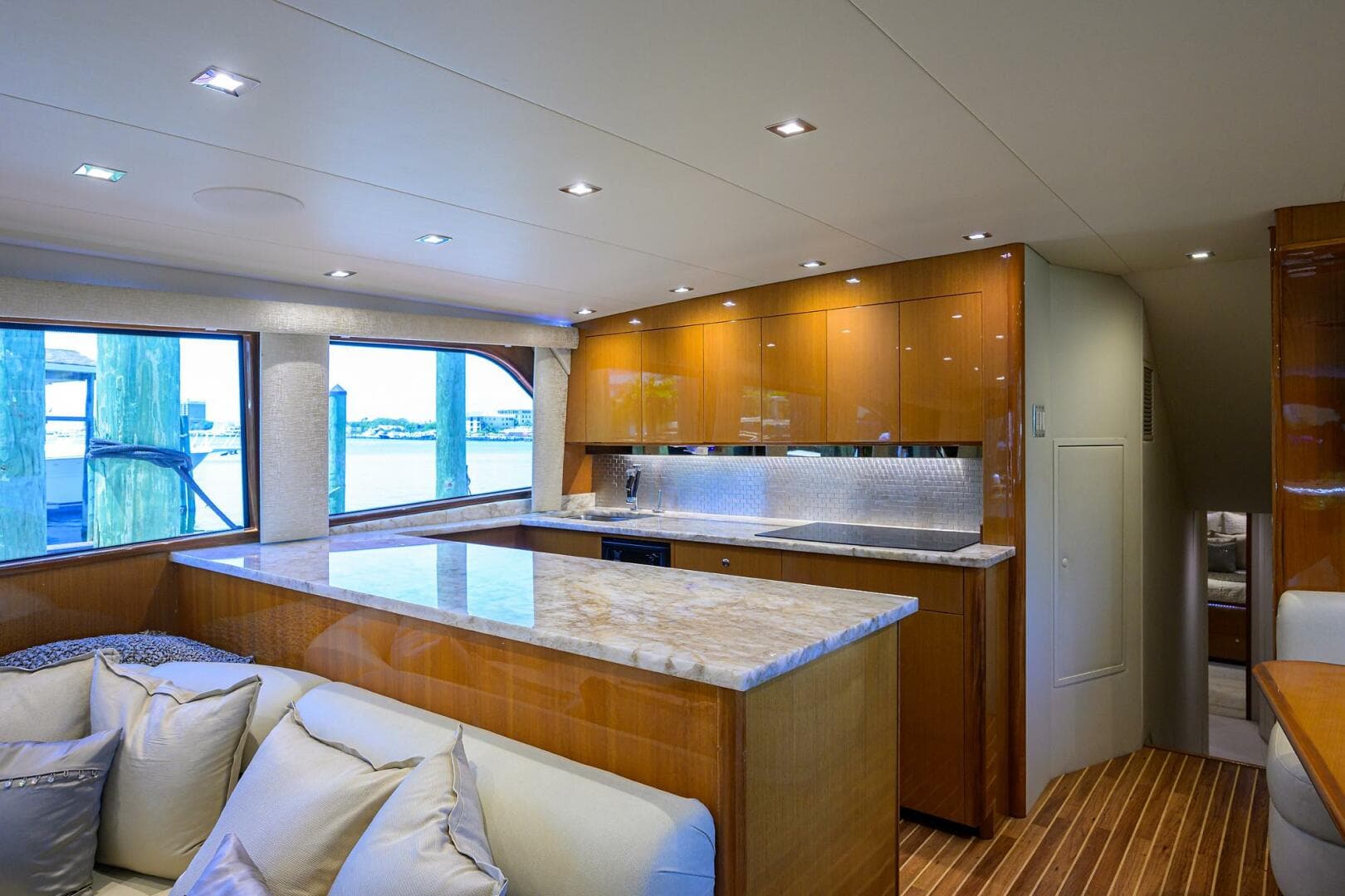 Luxurious interior of 2004 Viking 65 Enclosed Bridge yacht with modern kitchen and seating area.