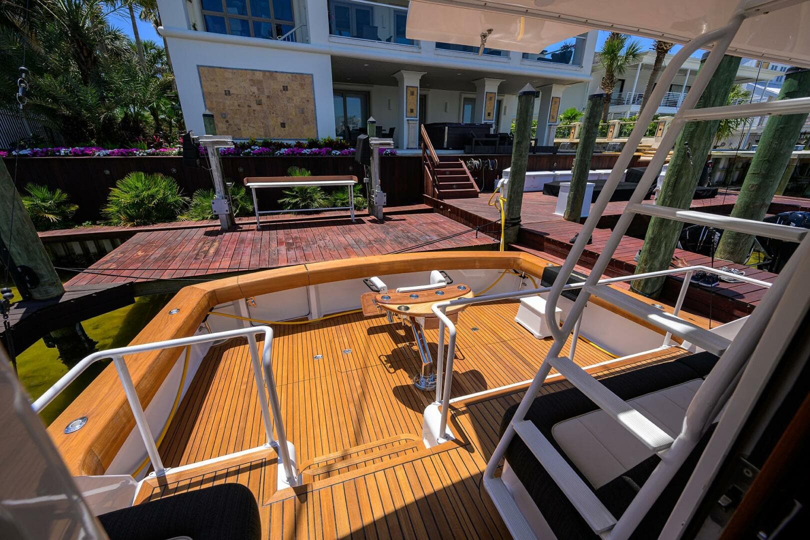 2004 Viking 65 Enclosed Bridge w/Tower yacht docked at a wooden pier.