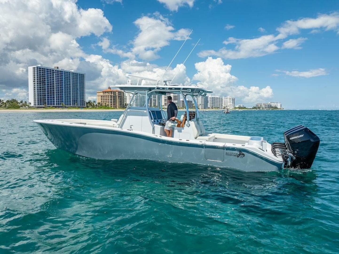 2025 Billfish 39 Center Console boat on clear blue water near city skyline.