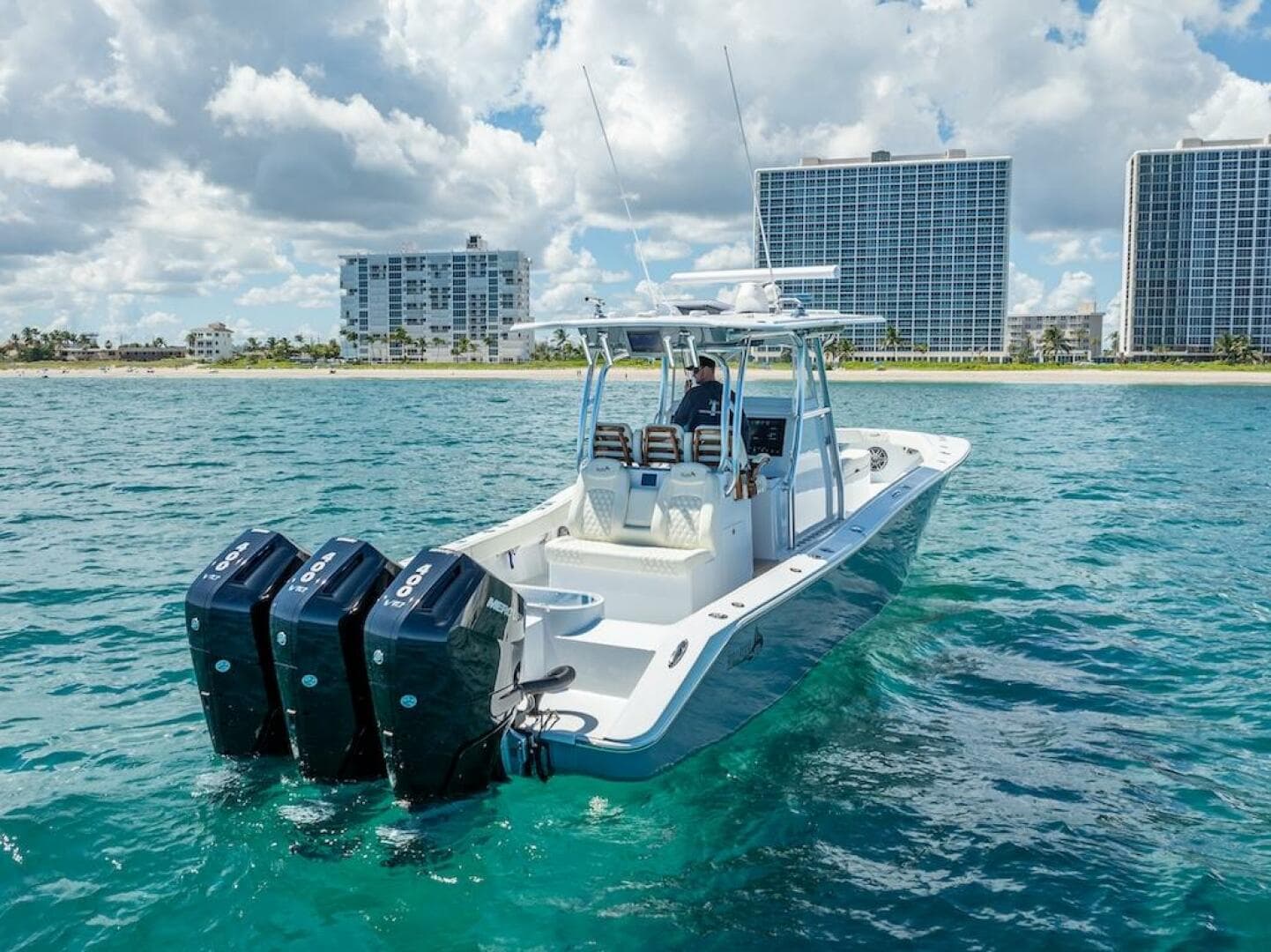 2025 Billfish 39 Center Console boat with tower on ocean near city skyline.