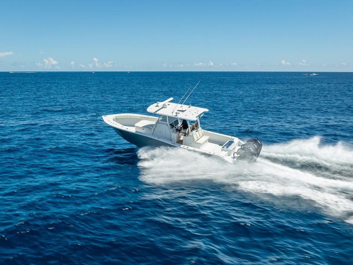 2025 Billfish 39 Center Console boat speeding on open ocean.