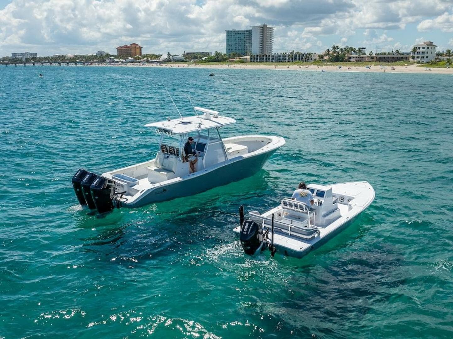 2025 Billfish 39 Center Console with Tower on ocean near beach.