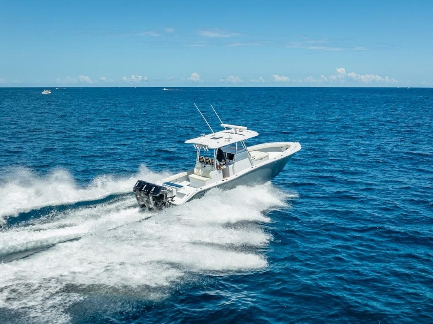 2025 Billfish 39 Center Console boat speeding on open ocean.