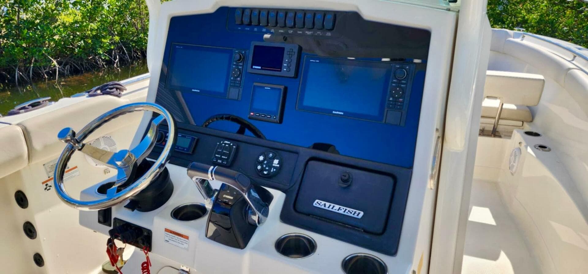 2021 Sailfish 272 CC boat dashboard with navigation controls and steering wheel.