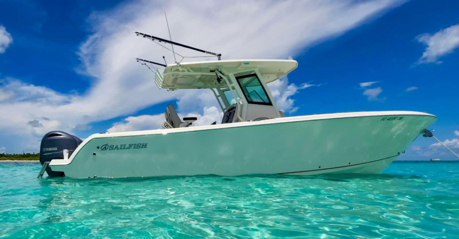 2021 Sailfish 272 CC boat on clear turquoise water under blue sky.