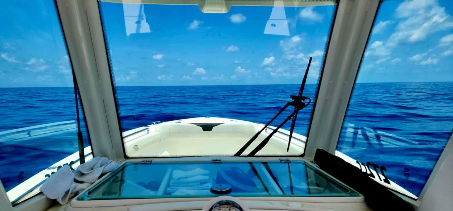 View from Sailfish 272 CC boat, 2021 model, navigating open ocean under clear blue skies.