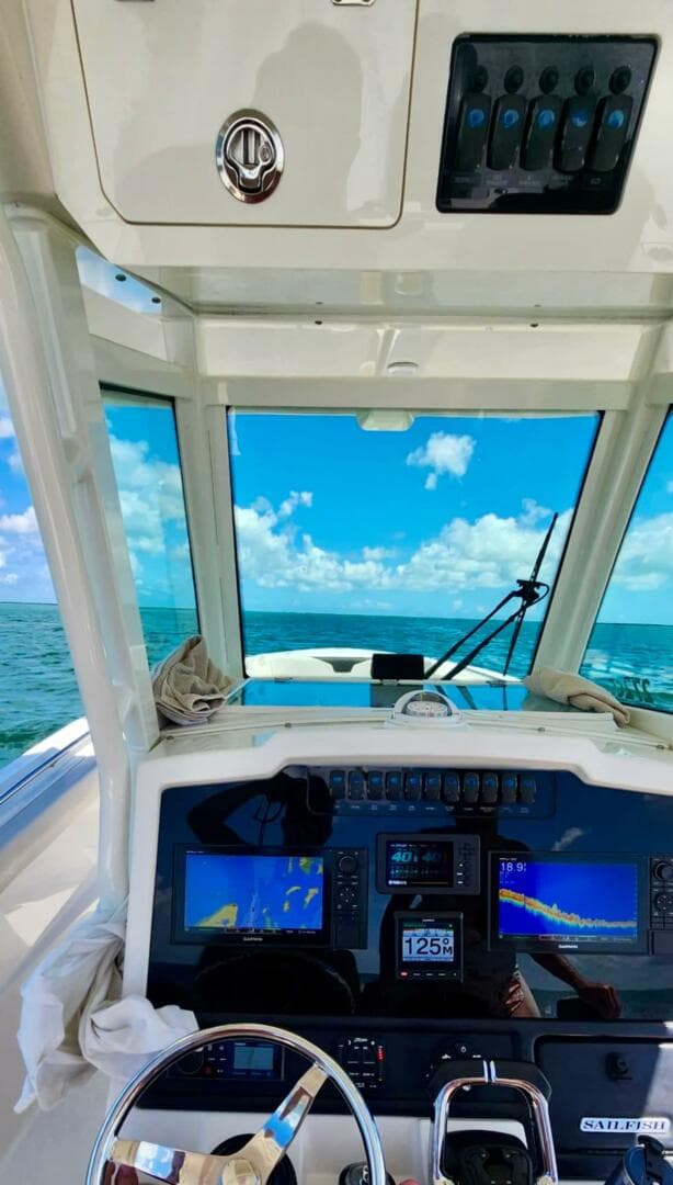 2021 Sailfish 272 CC boat dashboard with ocean view and navigation screens.