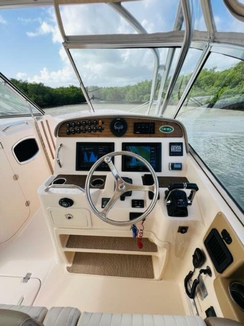 2014 Grady-White Freedom 335 boat cockpit with steering wheel and navigation controls.