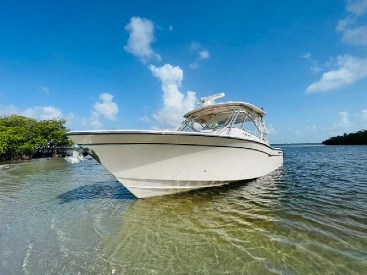 2014 Grady-White Freedom 335 boat in shallow water on a sunny day.