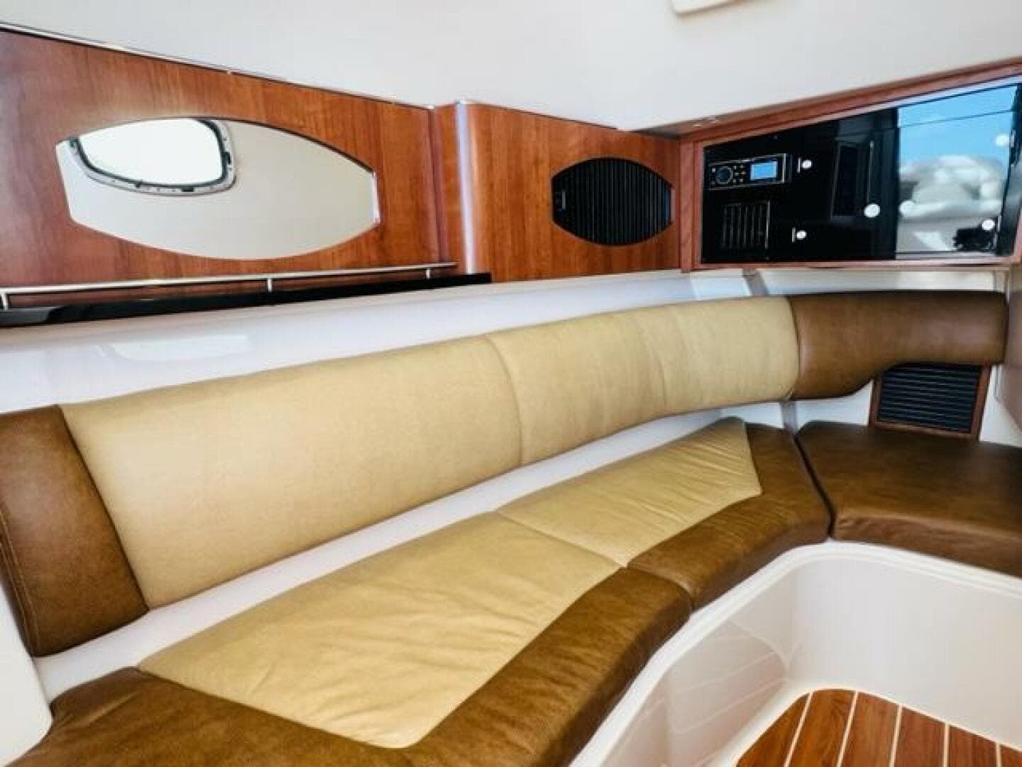 2014 Grady-White Freedom 335 cabin interior with cushioned seating and wooden accents.