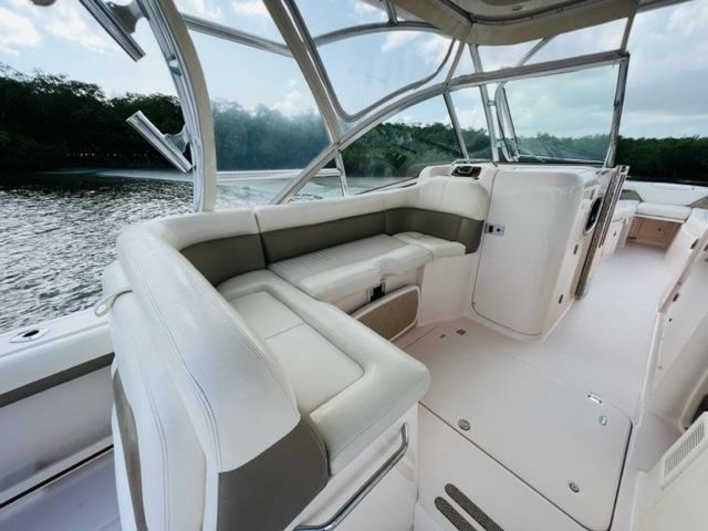 2014 Grady-White Freedom 335 boat interior with white seating and scenic water view.