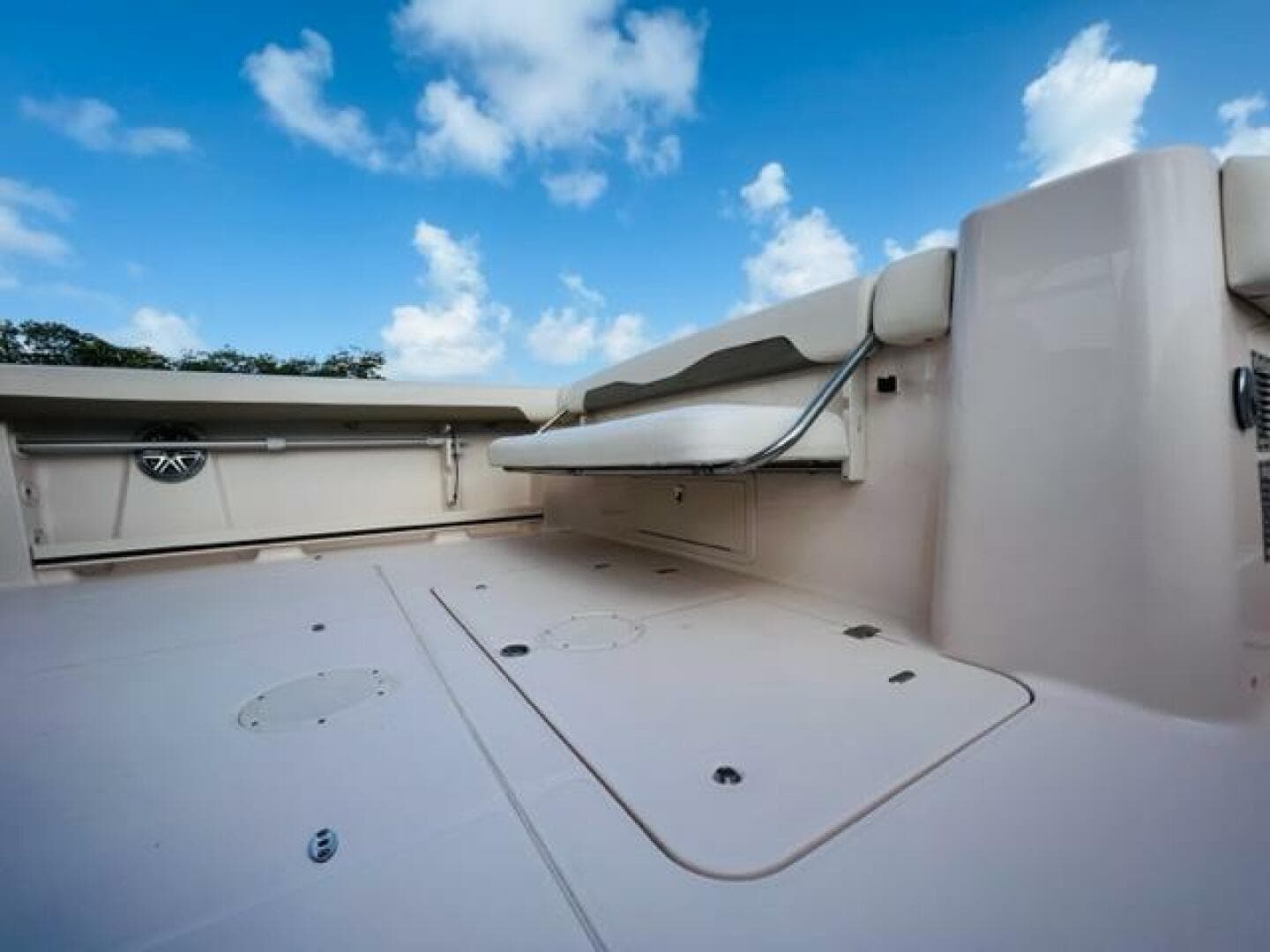 2014 Grady-White Freedom 335 boat deck with foldable seating under a blue sky.