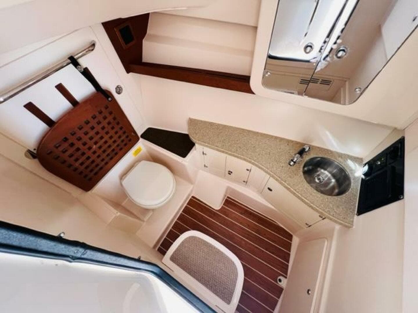 2014 Grady-White Freedom 335 boat interior with toilet, sink, and wooden flooring.