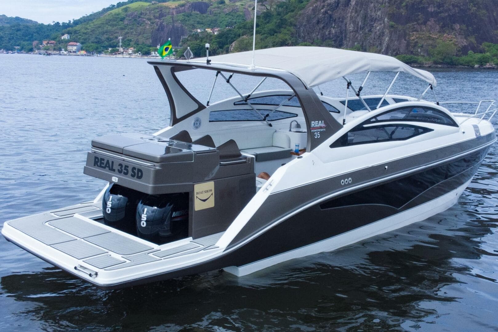 Luxury Real 35 Special Deck (SD) 2023 motorboat on serene water with scenic background.