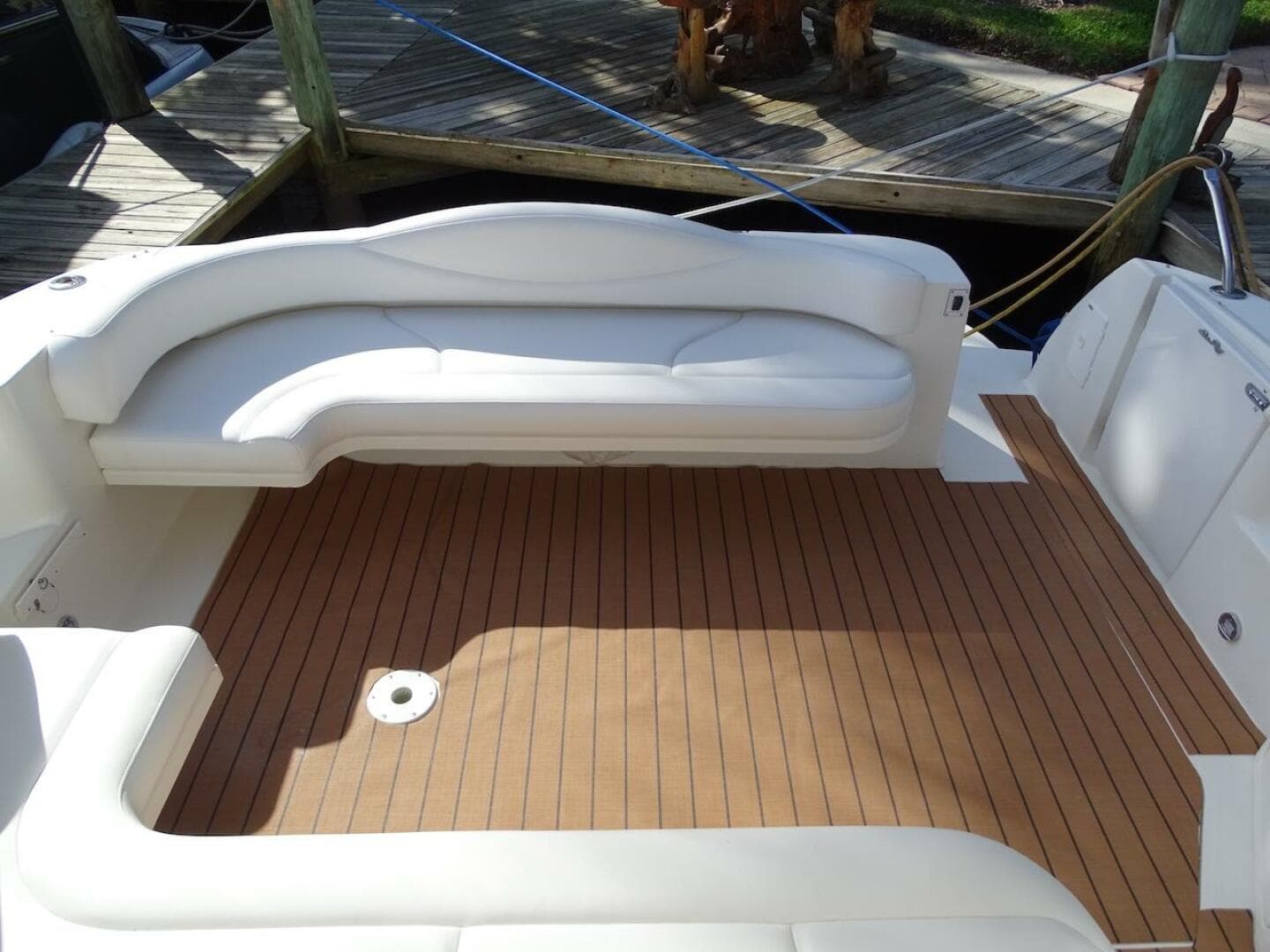 2001 Sea Ray 410 Sundancer boat deck with white seating and wooden flooring.