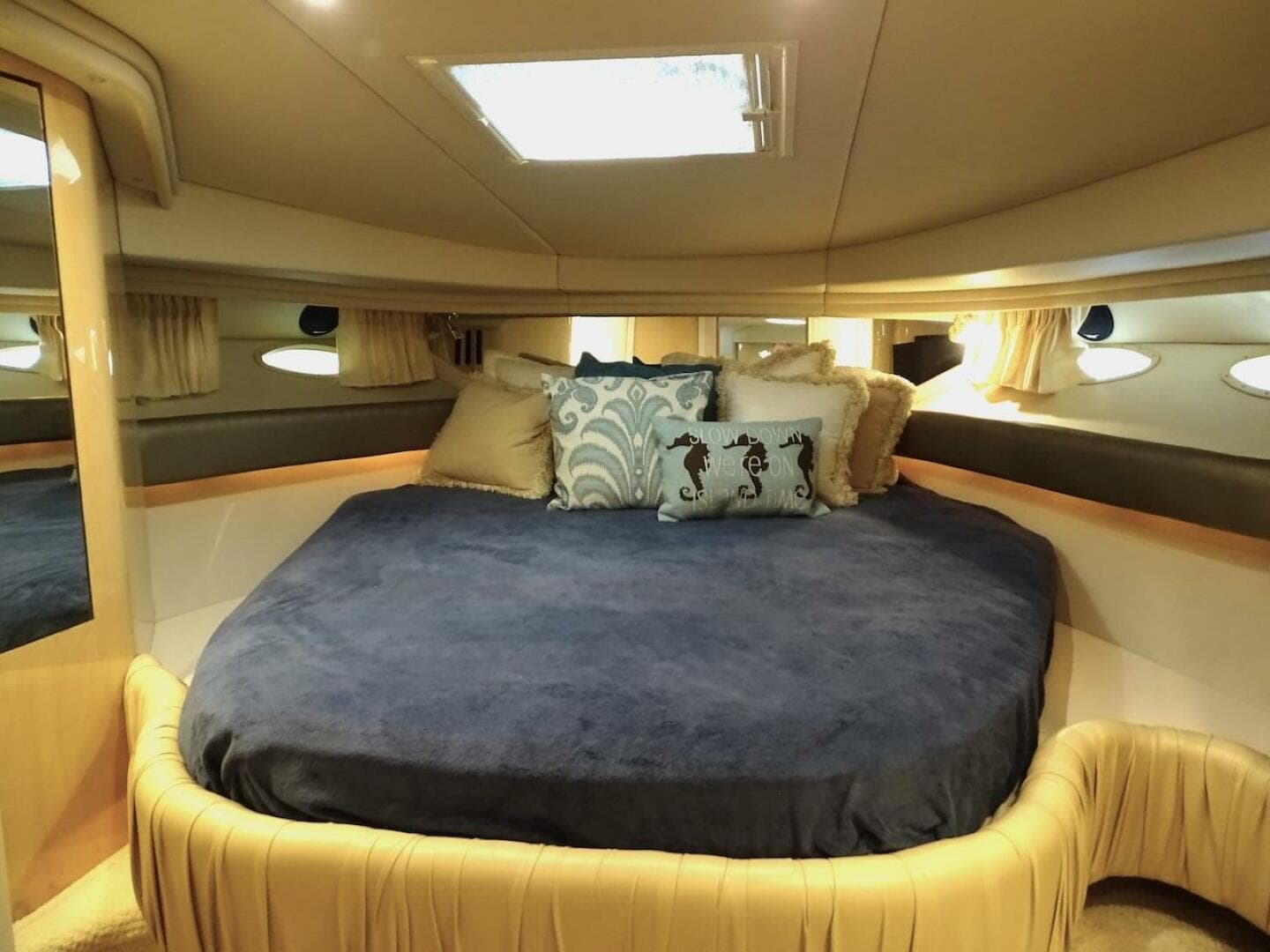 Luxurious bedroom interior of 2001 Sea Ray 410 Sundancer yacht with plush bedding.
