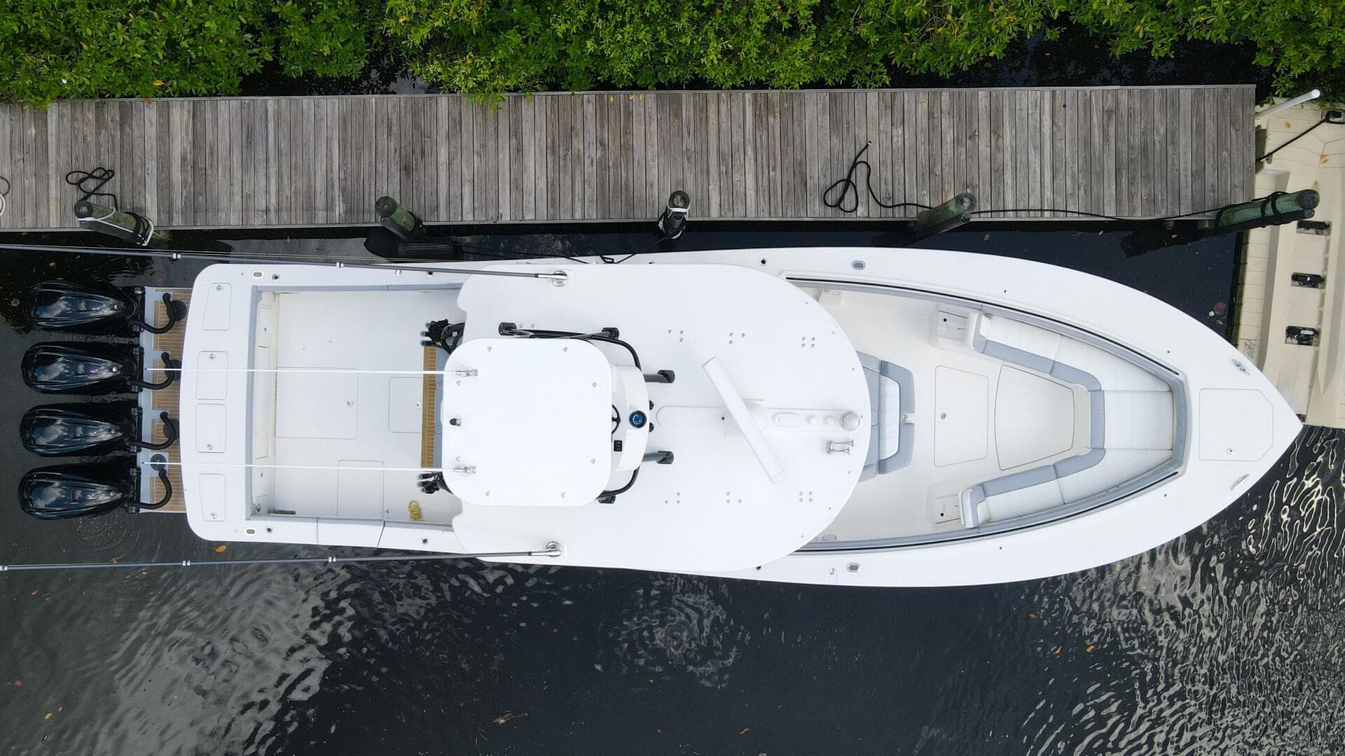 Aerial view of a 2020 Regulator 41 boat docked by a wooden pier.