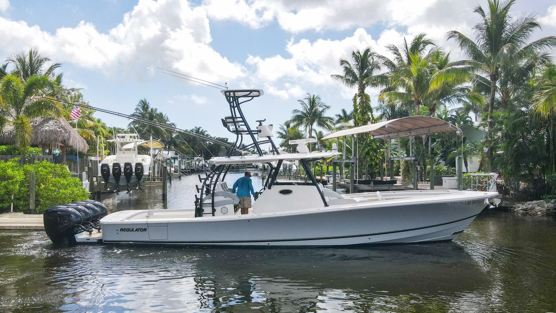 2020 Regulator 41 boat docked in a tropical marina with palm trees.