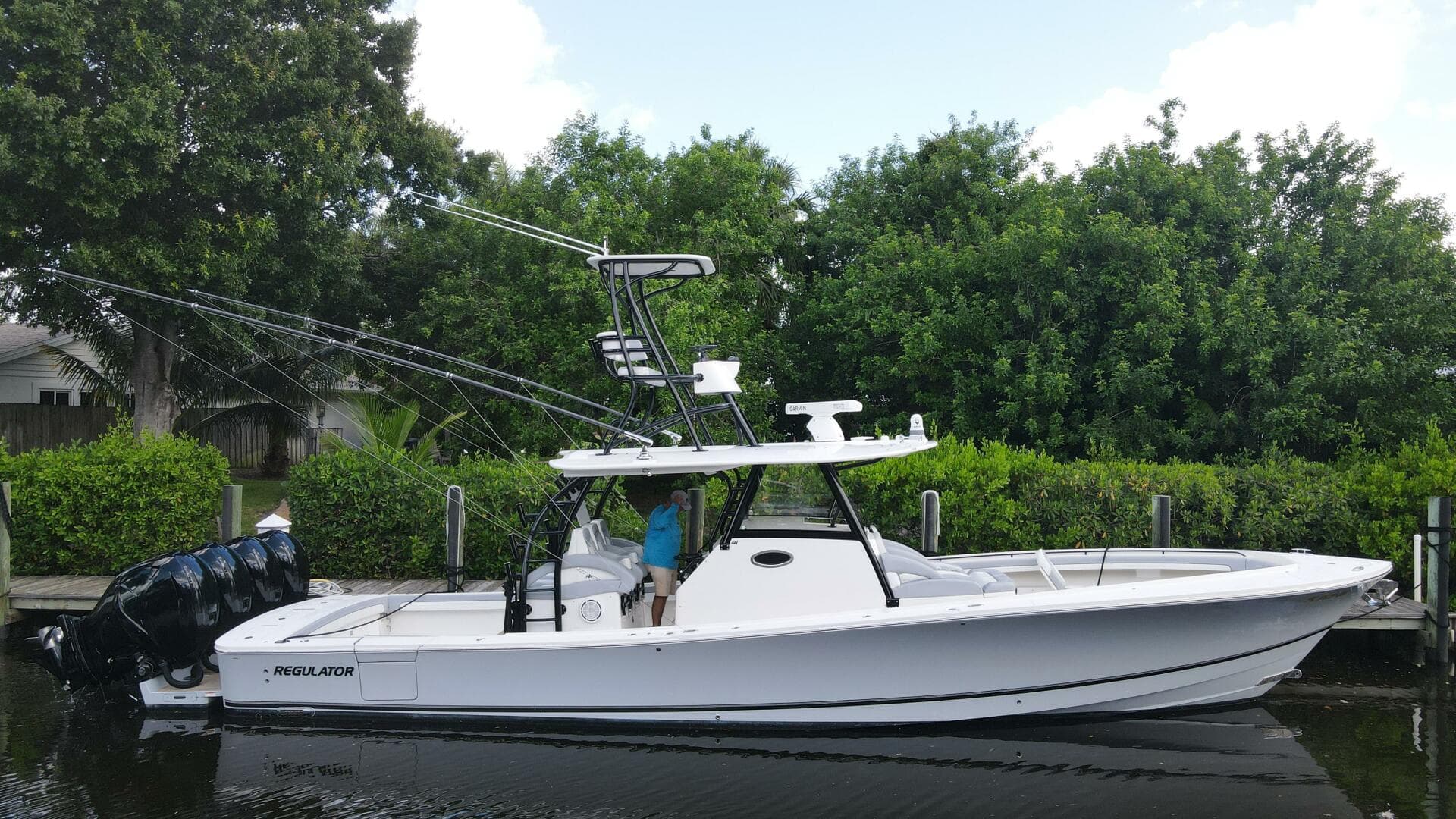 2020 Regulator 41 boat docked near lush greenery.