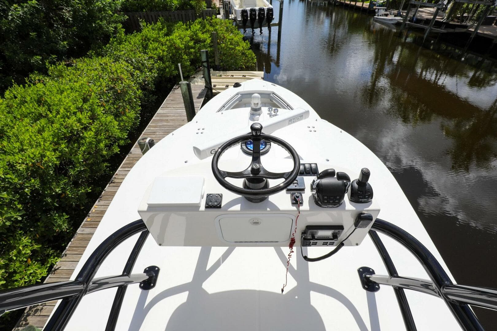 2020 Regulator 41 boat helm station docked by a canal.