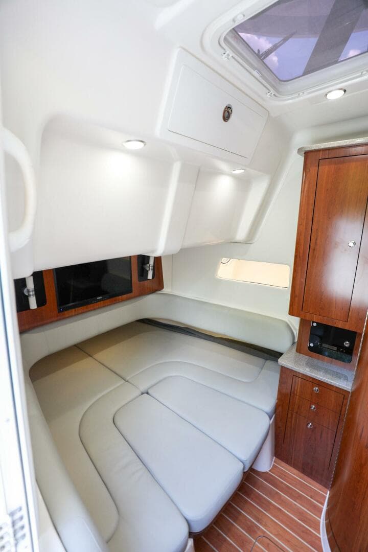 2020 Regulator 41 boat cabin with leather seating and wooden cabinetry.