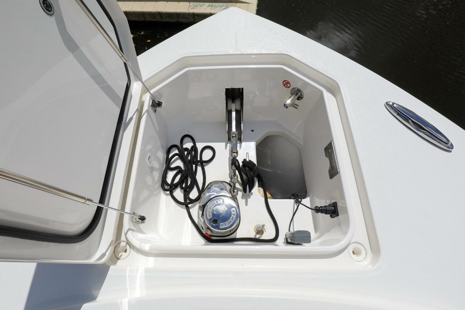 Open storage compartment on a 2020 Regulator 41 boat with anchor and ropes.