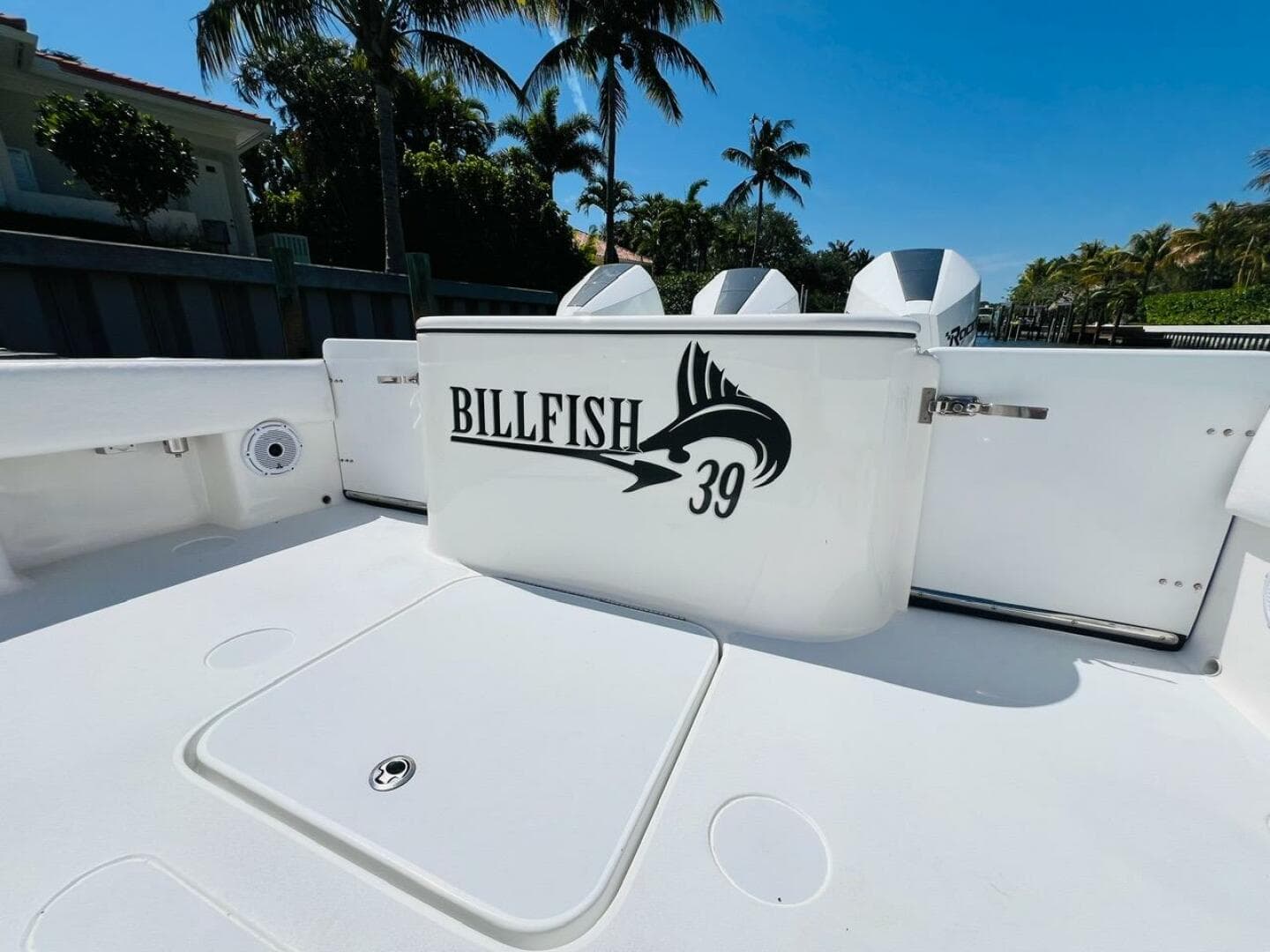 2015 Billfish 39 Custom CC boat deck with logo, palm trees in background.