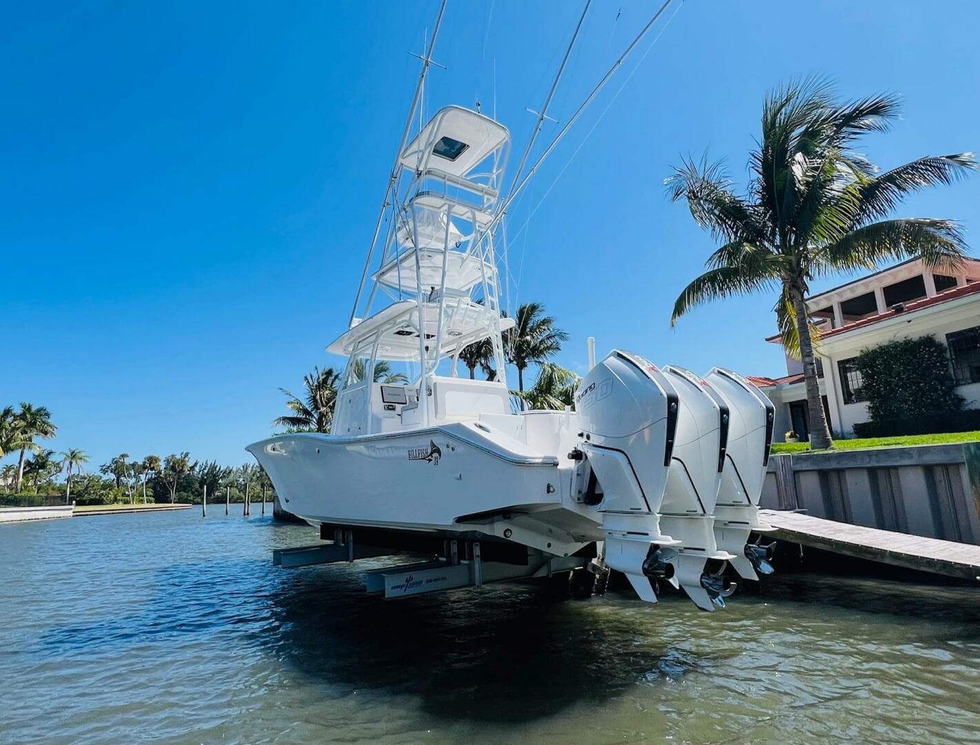 2015 Billfish 39 Custom CC boat docked by a waterfront property.