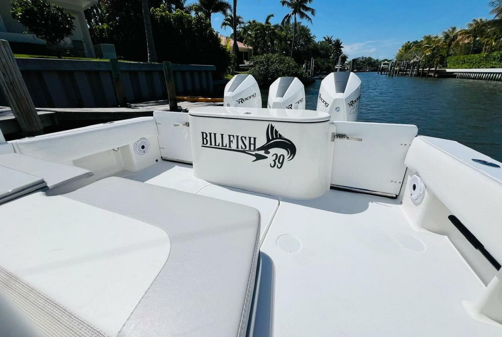 Billfish 39 Custom CC 2015 boat interior with triple outboard engines, docked by a canal.