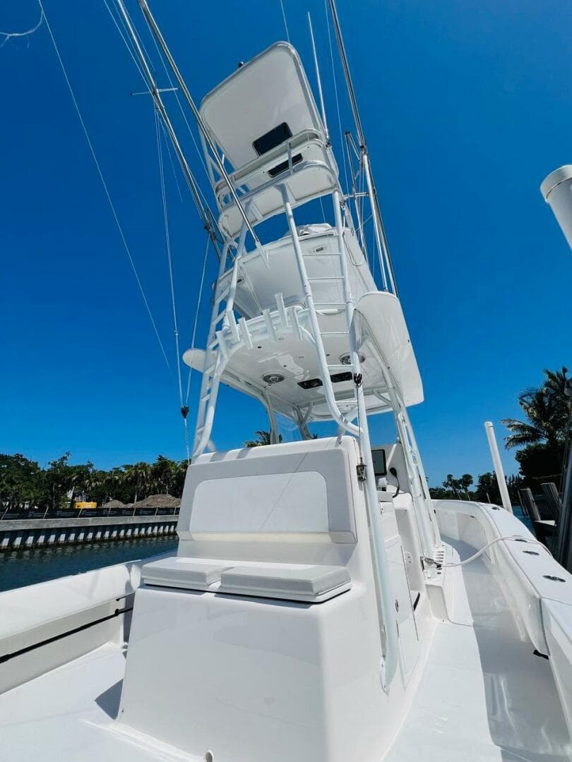 2015 Billfish 39 Custom CC boat with tower against a clear blue sky.