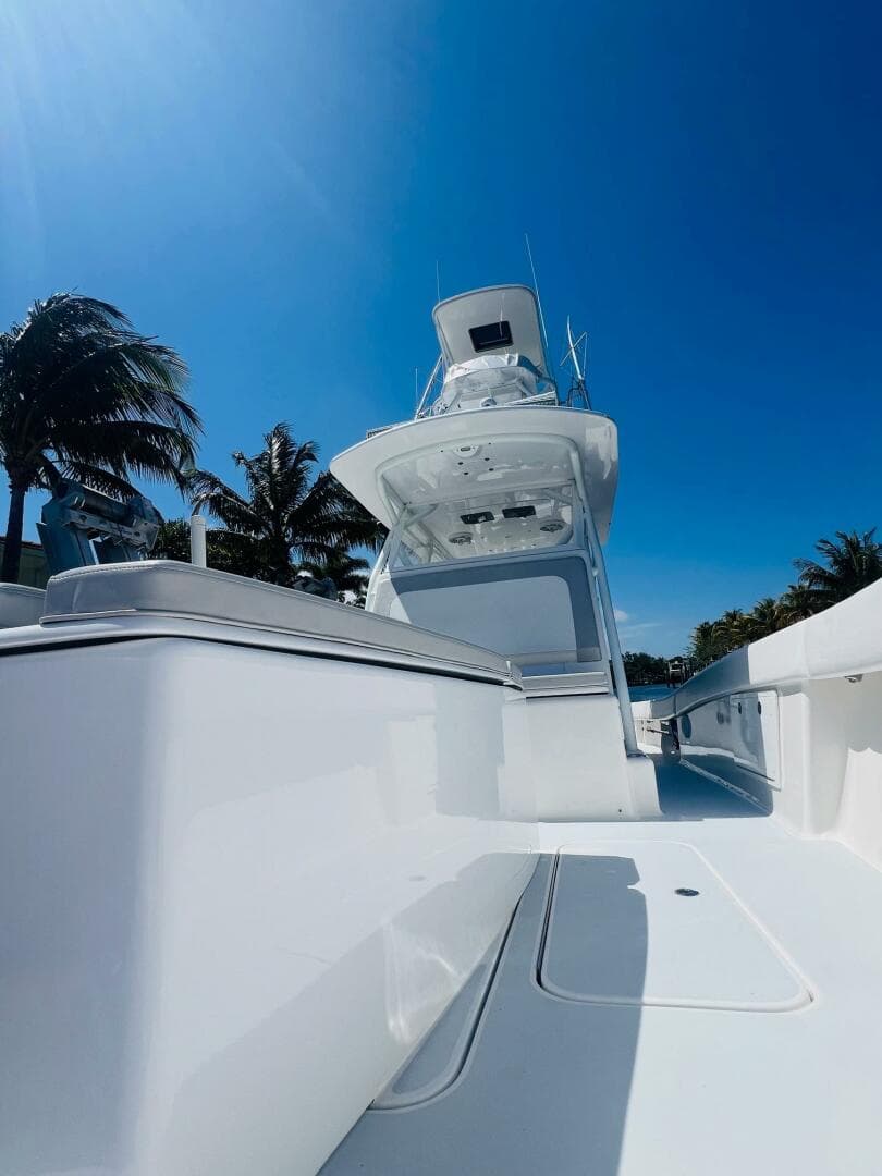 2015 Billfish 39 Custom CC boat with clear blue sky and palm trees.
