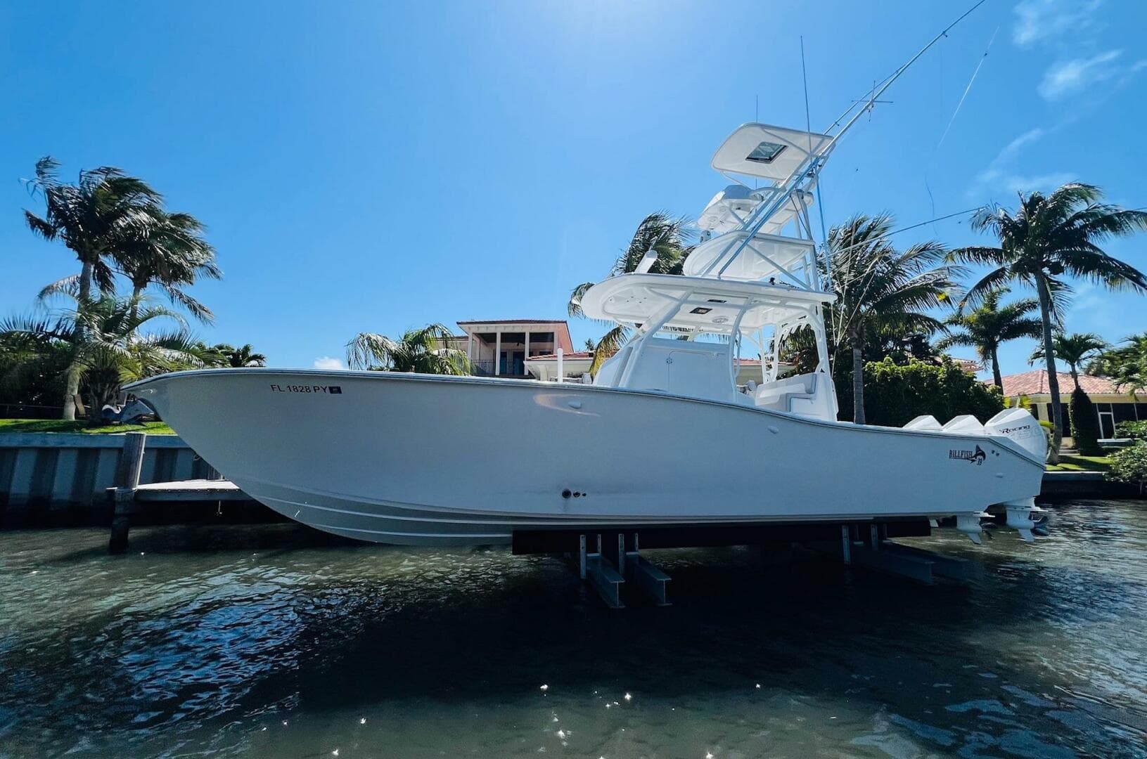 2015 Billfish 39 Custom CC boat docked near palm trees.