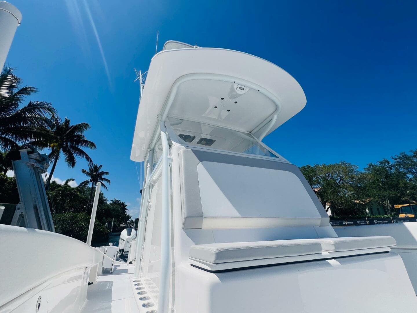 2015 Billfish 39 Custom CC boat under clear blue sky with palm trees.