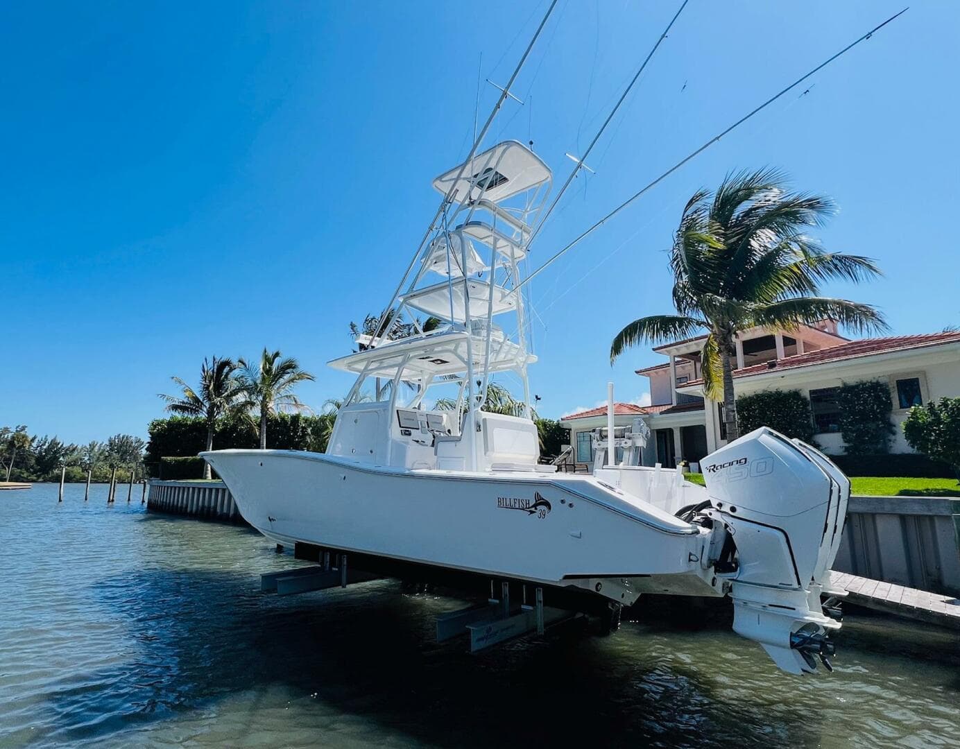 2015 Billfish 39 Custom CC boat docked near waterfront home.