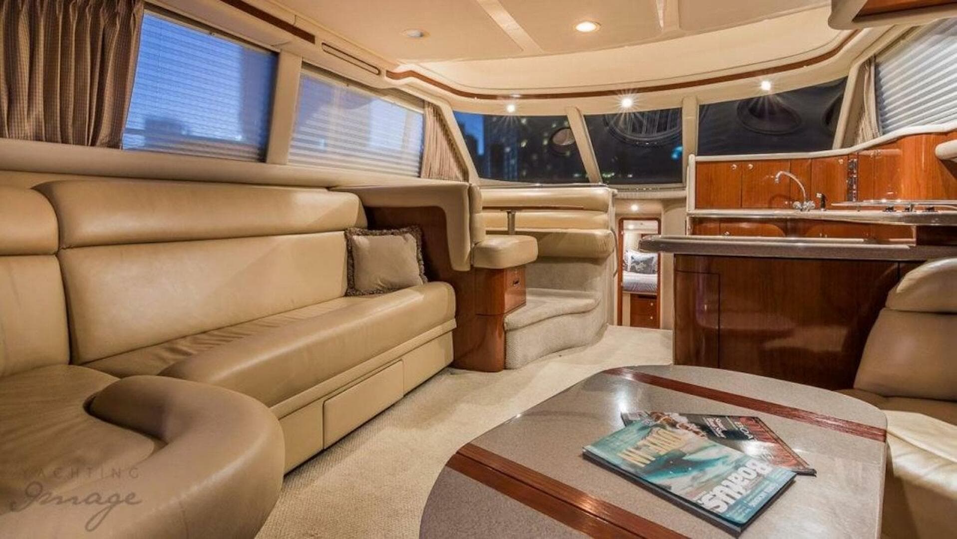 Luxurious interior of a 1998 Sea Ray 480 Sedan Bridge yacht with leather seating and modern kitchen.