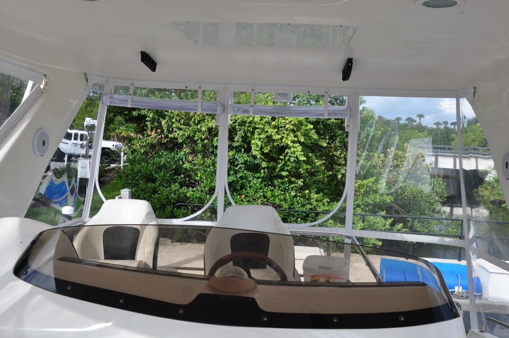 1998 Sea Ray 480 Sedan Bridge cockpit with dual seats and clear canopy.