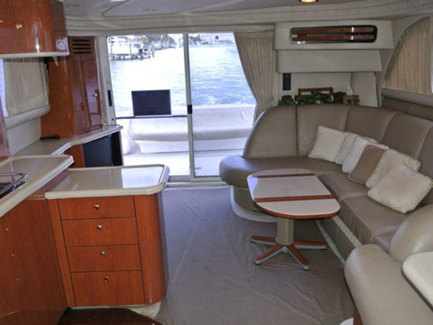 Interior of 1998 Sea Ray 480 Sedan Bridge yacht with modern furnishings and waterfront view.