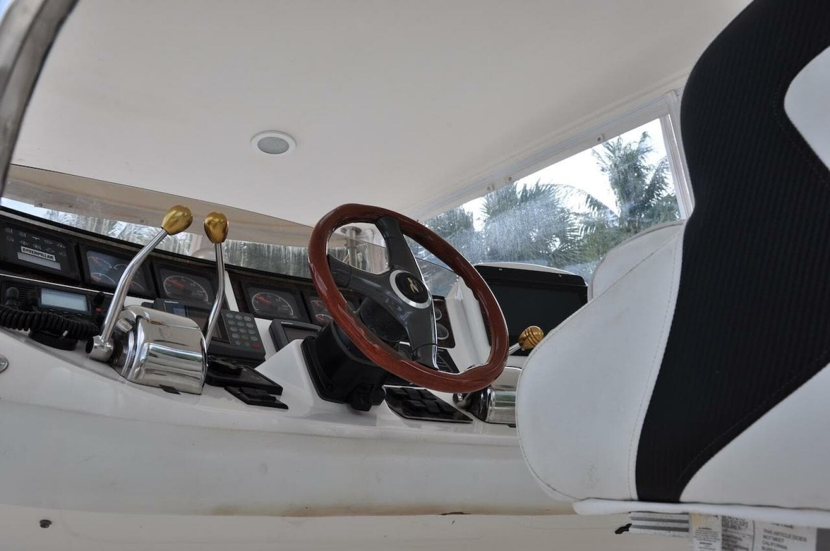 Interior helm of a 1998 Sea Ray 480 Sedan Bridge yacht with steering wheel and controls.