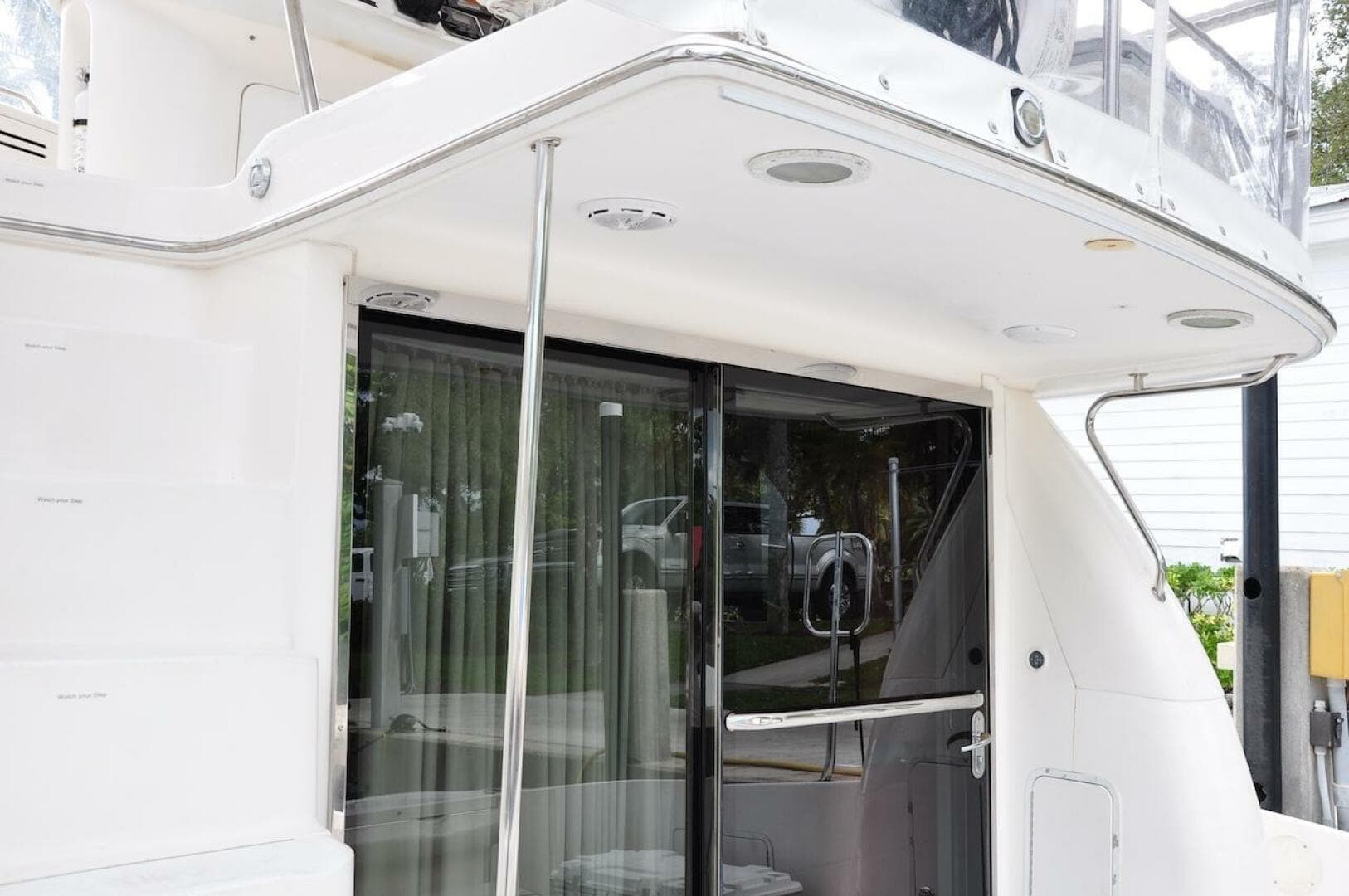 1998 Sea Ray 480 Sedan Bridge yacht, rear deck view with sliding glass door.