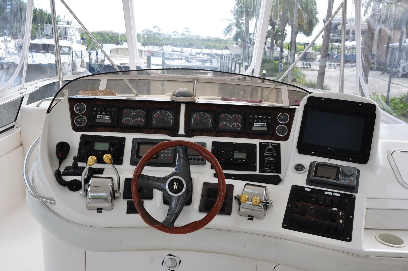 1998 Sea Ray 480 Sedan Bridge helm with steering wheel and control panel.