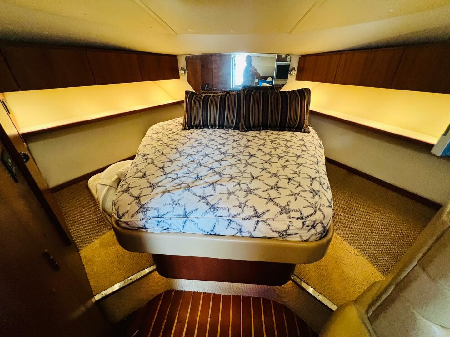 Luxurious cabin interior of 2003 Tiara Yachts 3800 Open with cozy bed and ambient lighting.