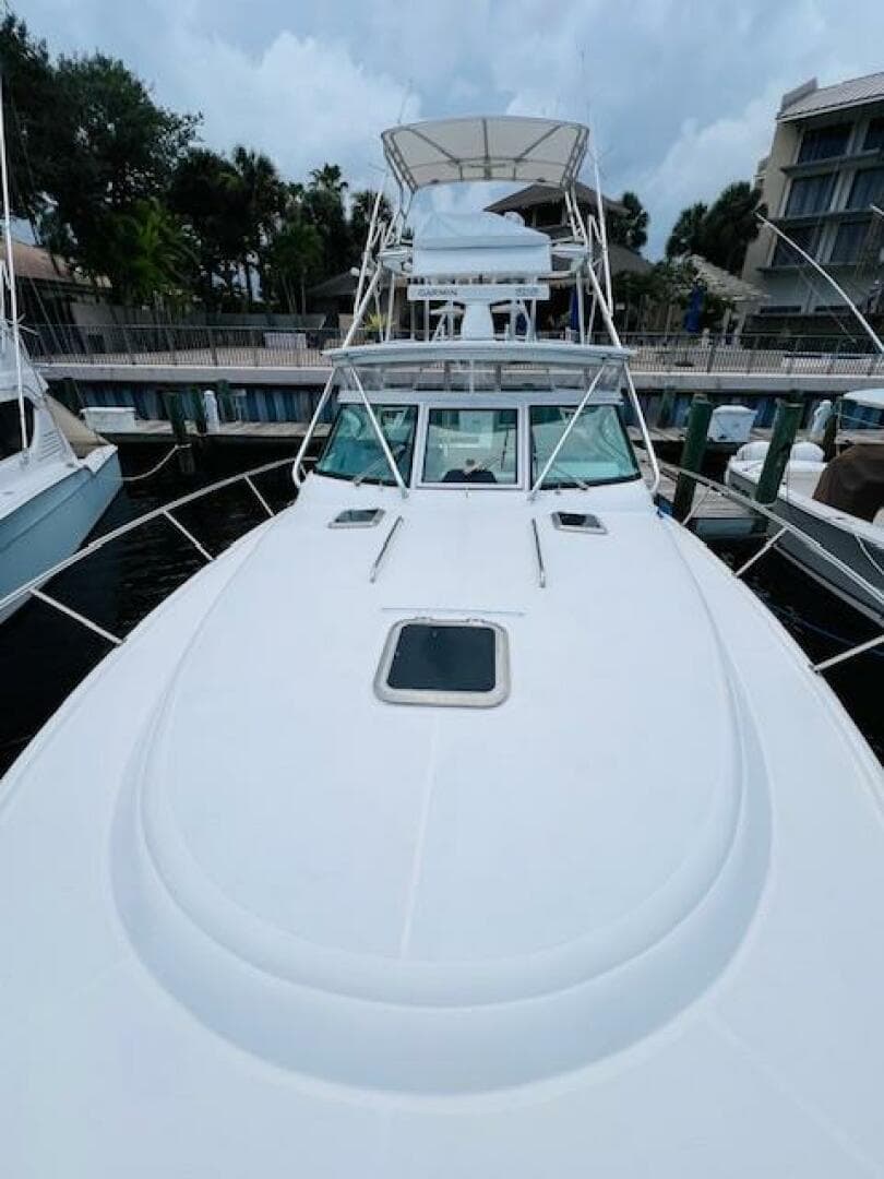 2003 Tiara Yachts 3800 Open docked, showcasing sleek design and spacious deck.