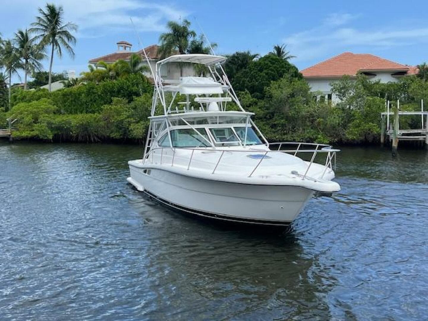 2003 Tiara Yachts 3800 Open cruising on a scenic waterway with lush greenery.